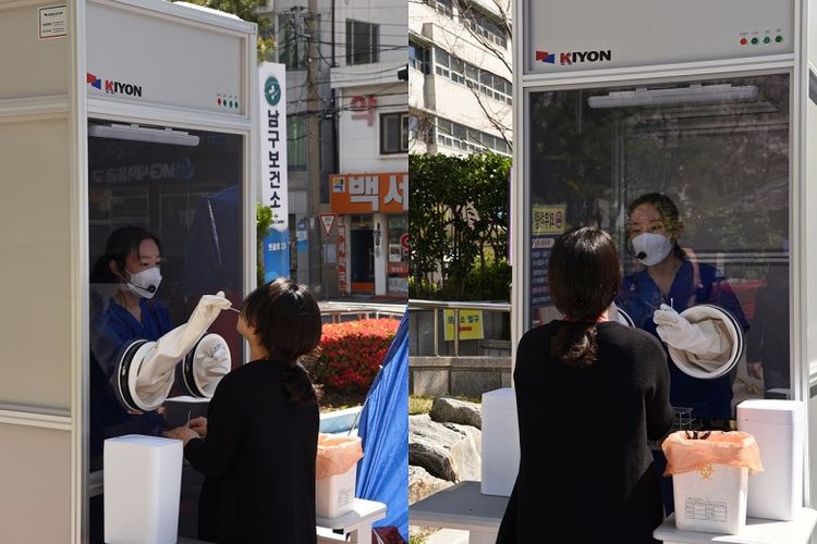 Sebuah bilik pengujian (booth) di pusat kesehatan masyarakat di Busan memungkinkan pekerja medis untuk menyeka (uji swab) pasien tanpa harus mengenakan alat pelindung penuh. (Pusat Kesehatan Busan Nam-gu)