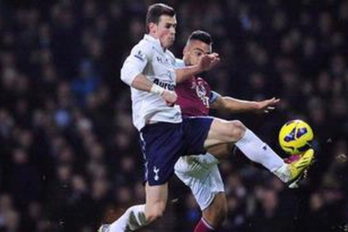 Gelandang serang Tottenham Hotspurs dari Wales, Gareth Bale (kiri), berebut bola melawan bek West Ham United dari Selandia Baru, Winston Reid (kanan), dalam laga pekan ke-27 Premier League di Stadion Boleyn Ground, Upton Park, London timur, Senin (25/2/2013). 