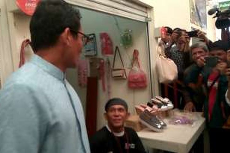Calon wakil gubernur DKI Jakarta Sandiaga Uno menyanyi bersama seorang pedagang di Pasar Pesanggrahan, Senin (21/11/2016).