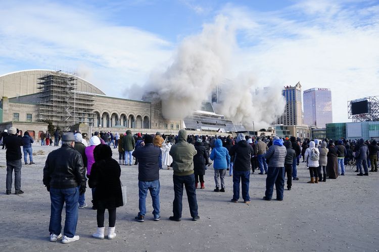 Orang-orang di Atlantic City, New Jersey, Amerika Serikat, menonton langsung kasino Trump Plaza yang diledakkan pada Rabu (17/2/2021). Gedung itu dulu sempat menjadi kebanggaan Donald Trump dan menjadi simbol kejayaan masa lalunya.