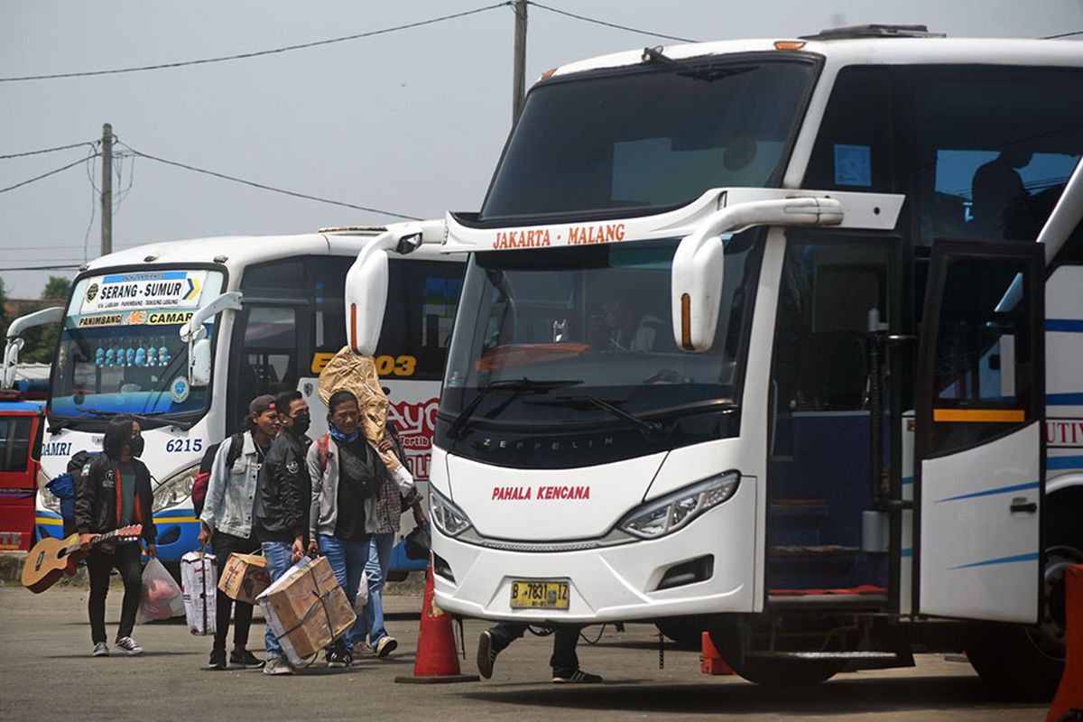 Sejumlah warga membawa barang bawaan menuju bis antar provinsi untuk mudik lebih awal di Terminal Bus Pakupatan, Serang, Banten, Kamis (23/4/2020). Meski pemerintah melarang mudik lebaran tahun 2020, sejumlah warga tetap pulang ke kampung halamannya sebelum puasa dengan alasan sudah tidak ada pekerjaan meski nantinya harus menjalani isolasi mandiri.