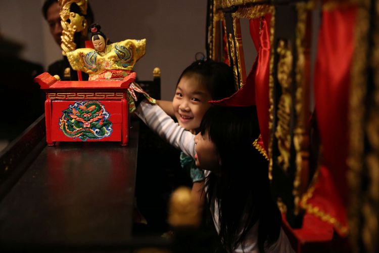 Seorang anak memainkan salah satu karakter wayang potehi saat acara pameran Wayang Potehi di Bentara Budaya Jakarta, Palmerah Selatan, Jakarta, Kamis (03/05/2018). Acara pameran dengan tema Waktu Hidupkan Kembali Potehi akan berlangsung dari tanggal 4 - 12 Mei 2018.