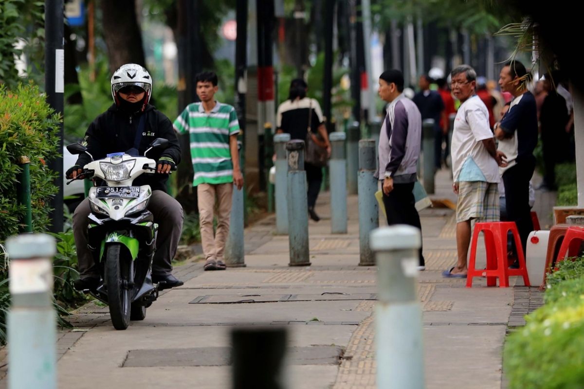 Pengendara sepeda motor yang melintasi trotoar di Jalan Kebon Sirih, Jakarta Pusat, Senin (17/7/2017). Pengendara sering memanfaatkan trotoar untuk memotong jalan agar bisa lebih cepat ketimbang melewati jalan raya.