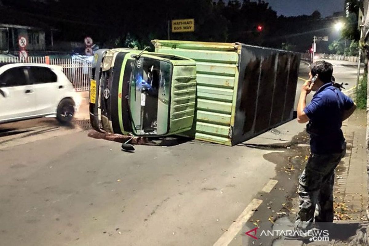 Truk boks bermuatan sembako terguling di Jalan Raya Pondok Gede, Minggu (5/4/2020) pagi. Petugas Sudin Perhubungan Jaktim menyebut pengendara mengantuk hingga menabrak pembatas jalan. 