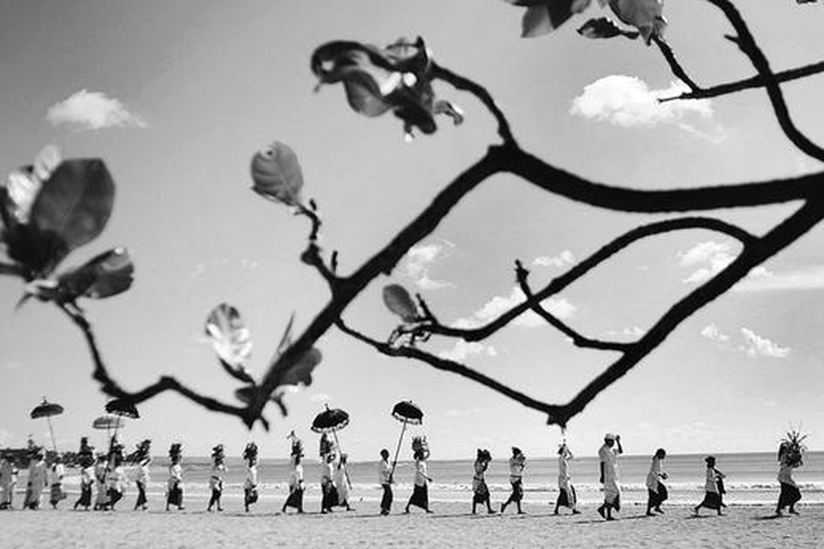 Umat Hindu menyusuri garis pantai menuju tempat upacara Melasti di Pantai Kuta, Bali, Sabtu (13/3). Upacara Melasti, yang merupakan sarana bersih diri umat Hindu dengan melarung atau membuang segala keburukan ke laut, diselenggarakan menjelang perayaan hari raya Nyepi Tahun Baru Saka 1932.