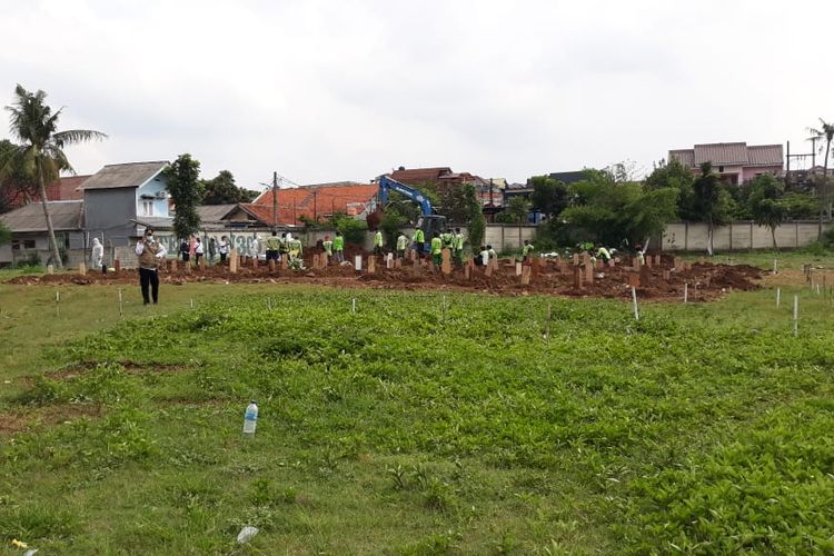 Proses pemakaman jenazah Covid-19 di Taman Pemakaman Umum (TPU) Srengseng Sawah, Jagakarsa, Jakarta Selatan pada Rabu (13/1/2021).