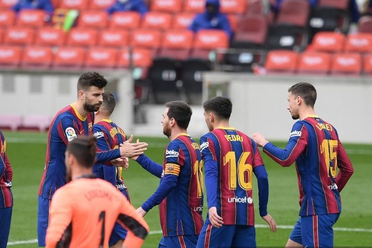 Penyerang Barcelona Barcelona Lionel Messi (tengah) merayakan dengan bek Spanyol Barcelona Gerard Pique setelah mencetak gol selama pertandingan sepak bola liga Spanyol antara FC Barcelona dan Cadiz CF di stadion Camp Nou di Barcelona pada 21 Februari 2021.