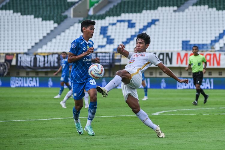 Firza Andika (putih) bek Persija Jakarta melakukan clearance dihadapan Ryan Kurnia dalam pertandingan pekan ke-28 Liga 1 2023-2024, antara Persib Bandung vs Persija Jakarta, Sabtu (9/3/2024) di Stadion Si Jalak Harupat (SJH) Soreang, Kabupaten Bandung. 