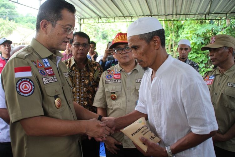 Menteri Sosial (Mensos) Republik Indonesia, Juliari P. Batubara saat menyerahkan santunan kepada keluarga korban meninggal. (Foto Dokumentasi Humas Ditjen Perlindungan dan Jaminan Sosial, Kementerian Sosial)