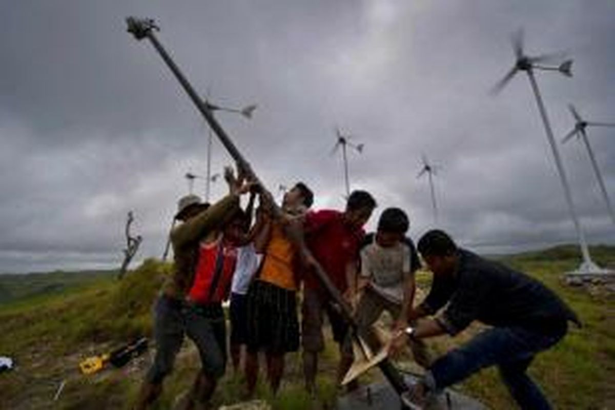 Warga bergotong-royong mendirikan kincir angin tambahan di kawasan turbin angin di Desa Kamanggih, Pulau Sumba, 19 Maret 2014.