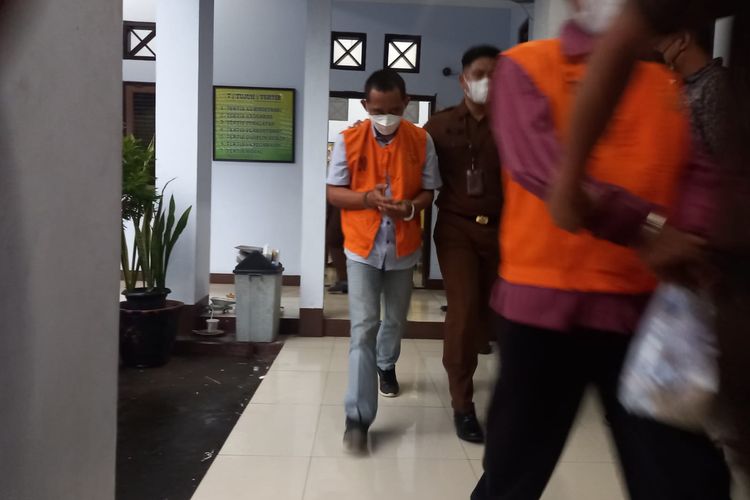 DITAHAN—Petugas Kejari Wonogiri menggiring kedua tersangka ke mobil tahanan untuk ditahan di Lapas Kelas IIB Wonogiri, Kamis (23/12/2021).