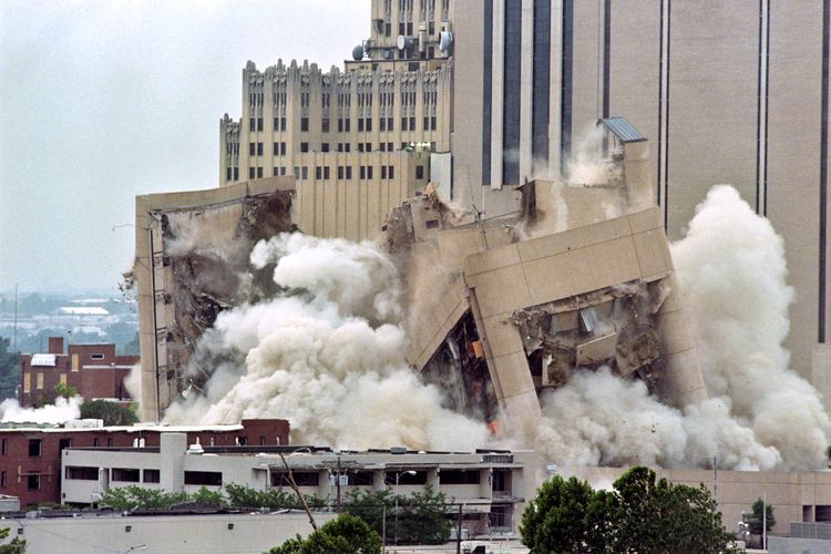 The Alfred P. Murrah Building collapses into itself after being imploded on May 23, 1995 in Oklahoma City. Some 100 pounds of dynamite brought the building down in about 5 seconds. The April 19 explosion of a car bomb in front of the Federal building left 168 dead and 680 injured. Timothy McVeigh, convicted on first-degree murder charges for the 19 April bombing, the worst terror attack on US soil, was sentenced to death in 1997. (Photo by PAUL BUCK / AFP)