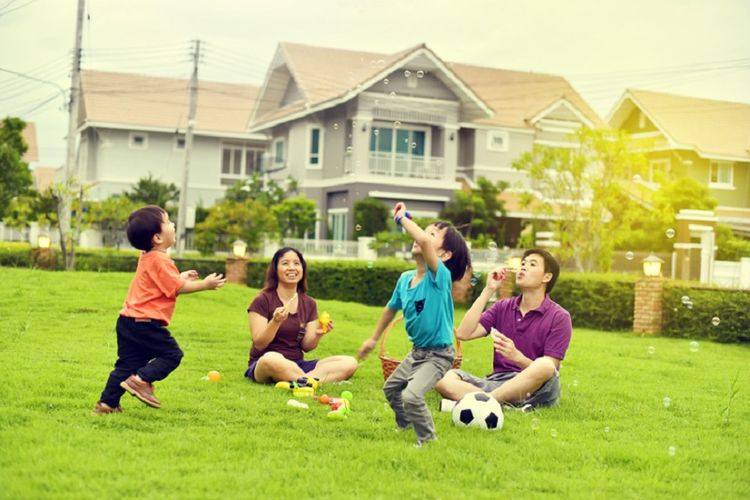 Asian family playing together in garden