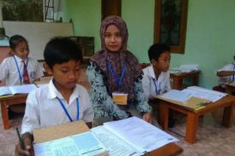 Siswa SDN II Kotah, Kecamatan Jrengik, Kabupaten Sampang, kerjakan soal-soal UN di rumah warga karena sekolahnya ambruk terkena longsor. 
