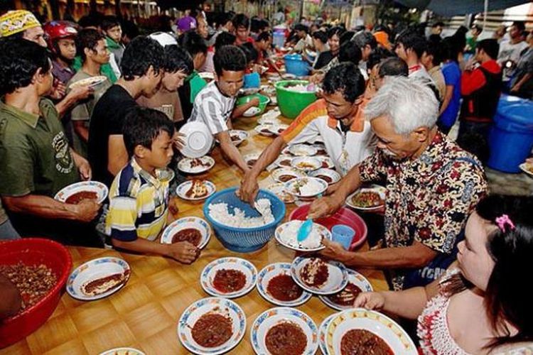 Masyarakat makan malam bersama sajian daging kerbau hasil kurban dalam prosesi adat Nalitn Taotn di Taman Budaya Sendawar, Kutai Barat, Kalimantan Timur, Kamis (7/11/2013). Prosesi adat ini tidak saja melibatkan etnis Tunjung dan Benuaq namun empat etnis lain Bahau Aoheng, Kenyah dan Melayu turut andil meramaikan acara tersebut.