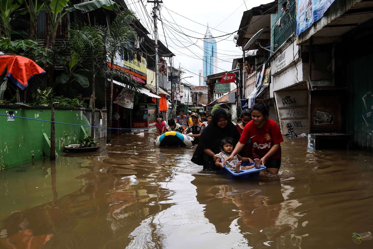 Petugas saat mengevakuasi warga menggunakan perahu karet saat banjir di Jalan Karet Pasar Baru, Karet Tengsin, Jakarta Pusat, Selasa (25/2/2020). Hujan deras sejak Senin dini hari membuat sejumlah daerah di Ibu Kota tergenang banjir.