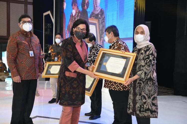 Menteri Keuangan (Menkeu) Sri Mulyani saat menyerahkan penghargaan kepada Sekretaris Utama LAN Reni Suzana dalam acara Rapat Koordinasi Nasional (Rakornas) Pelaksanaan Anggaran Tahun 2022 bertema Spending Better: Mewujudkan Ketahanan Fiskal di Gedung Dhanapala, Jakarta, Rabu (13/4/2022).