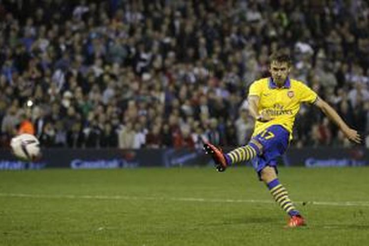 Bek Arsenal Nacho Monreal melepaskan tembakan dari titik putih yang berujung gol, pada babak adu penalti pertandingan putaran ketiga Piala Liga Inggris, antara timnya dan West Bromwich Albion, di The Hawthorns, Rabu (25/9/2013).