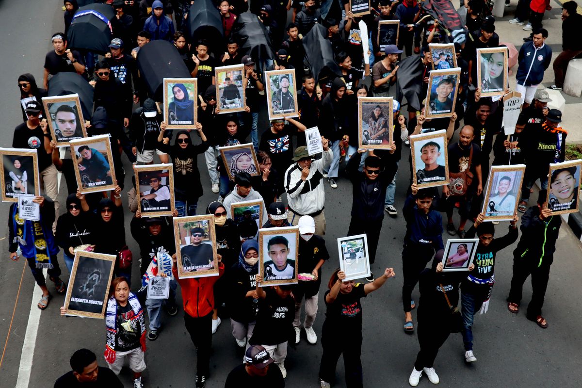 Sejumlah suporter Arema FC, Aremania membawa poster korban meninggal Tragedi Kanjuruhan saat melakukan aksi menuntut keadilan yang dilaksanakan di Kota Malang, Kamis (10/11/2022) siang.