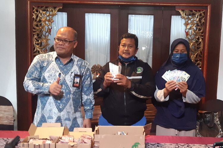 Kepala Kantor Perwakilan Bank Indonesia (KPwBI) Solo Nugroho Joko Prastowo menyerahkan uang pengganti kepada Samin didampingi istri di Kantor Bank Indonesia Solo, Kamis (15/9/2022).