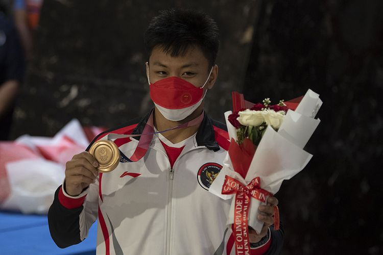 Lifter Rahmat Erwin Abdullah berpose dengan medali perunggu Olimpiade Tokyo 2020 setibanya di Bandara Soekarno Hatta, Tangerang, Banten, Rabu (4/8/2021). Selain Rahmat, pebulu tangkis Anthony Ginting, Apriyani Rahayu, Greysia Polii, Praveen Jordan, lifter Nurul Akmal, , petembak Vidya Rafika, sprinter Lalu Muhammad Zohri, dan Alvin Tehupeiory juga termasuk dalam kloter terakhir kepulangan kontingen Indonesia dari Olimpiade Tokyo.