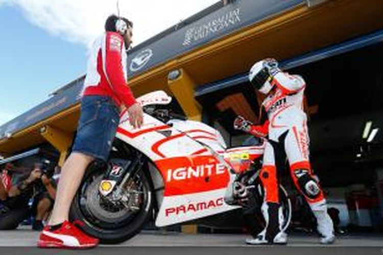 Pebalap Pramac Racing asal Kolombia, Yonny Hernandez melangkah menuju motornya saat uji coba resmi MotoGP di Sirkuit Valencia, Spanyol, Senin (11/11/2013).