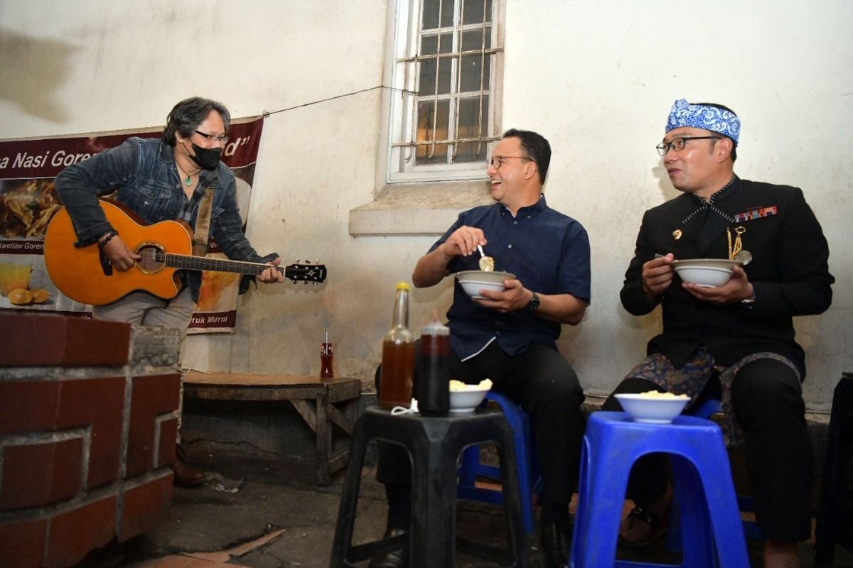 Gubernur Jawa Barat Ridwan Kamil bersama Gubernur DKI Jakarta Anies Baswedan saat menyantap Bubur PR di Jalan Asia Afrika, Kota Bandung, Kamis (24/2/2022) malam.