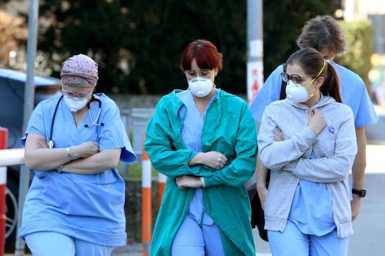 Orang-orang dan petugas kesehatan memakai masker wajah pelindung di luar rumah sakit di Padua, wilayah Veneto, Italia utara  EPA-EFE/NICOLA FOSSELLA