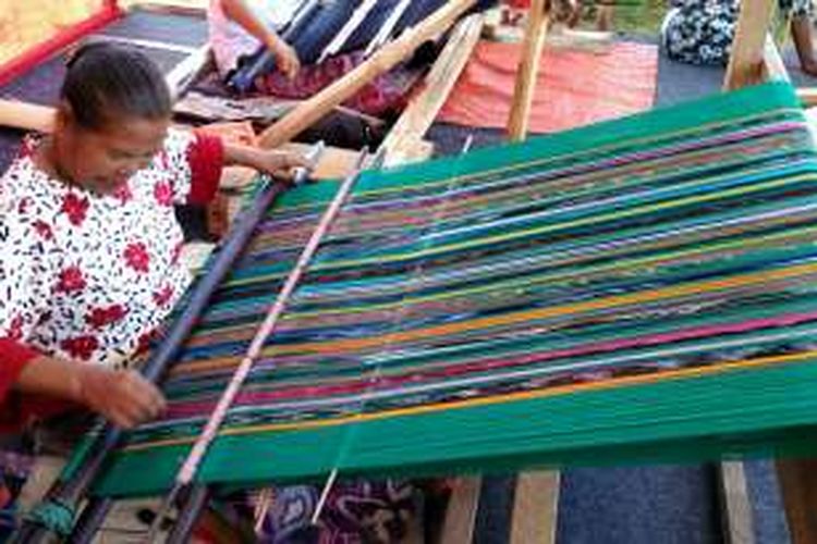 Mutiara Pandiangan (72), penenun dari Muara, Tapanuli Utara, Sumatera Utara, tengah menenun ulos Harungguan, Sabtu (10/9/2016). Mutiara adalah penenun yang menenun ulos Harungguan untuk Presiden Joko Widodo.