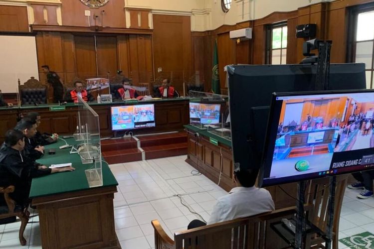 Three police members attend their trial at a courthouse in Surabaya on Thursday, March 16, 2023. Last year's deadly stampede happened during a match in Kanjuruhan Stadium in the East Java city of Malang, where 135 people were killed after police fired tear gas into supporters as they invaded the pitch. 