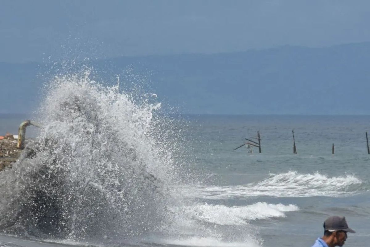 Gambar warga berdiri di pinggiran pantai Ampenan saat terjadi gelombang tinggi di sepanjang pesisir pantai Ampenan, Mataram, NTB. BMKG memperingatkan potensi banjir rob di pesisir NTB 19?26 November 2025 akibat fase bulan baru. Menurut BMKG, hujan intensitas tinggi bakal melanda sejumlah wilayah selama Natal 2025 dan Tahun Baru 2026 (Nataru 2026).