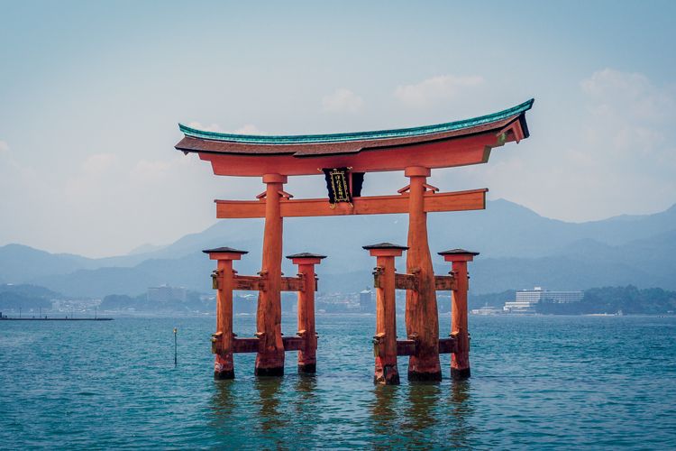 Gerbang atau torii Kuil Itsukushima di Pulau Miyajima, Jepang. Kuil ini terkenal akan torii yang seolah-olah mengambang di perairan.