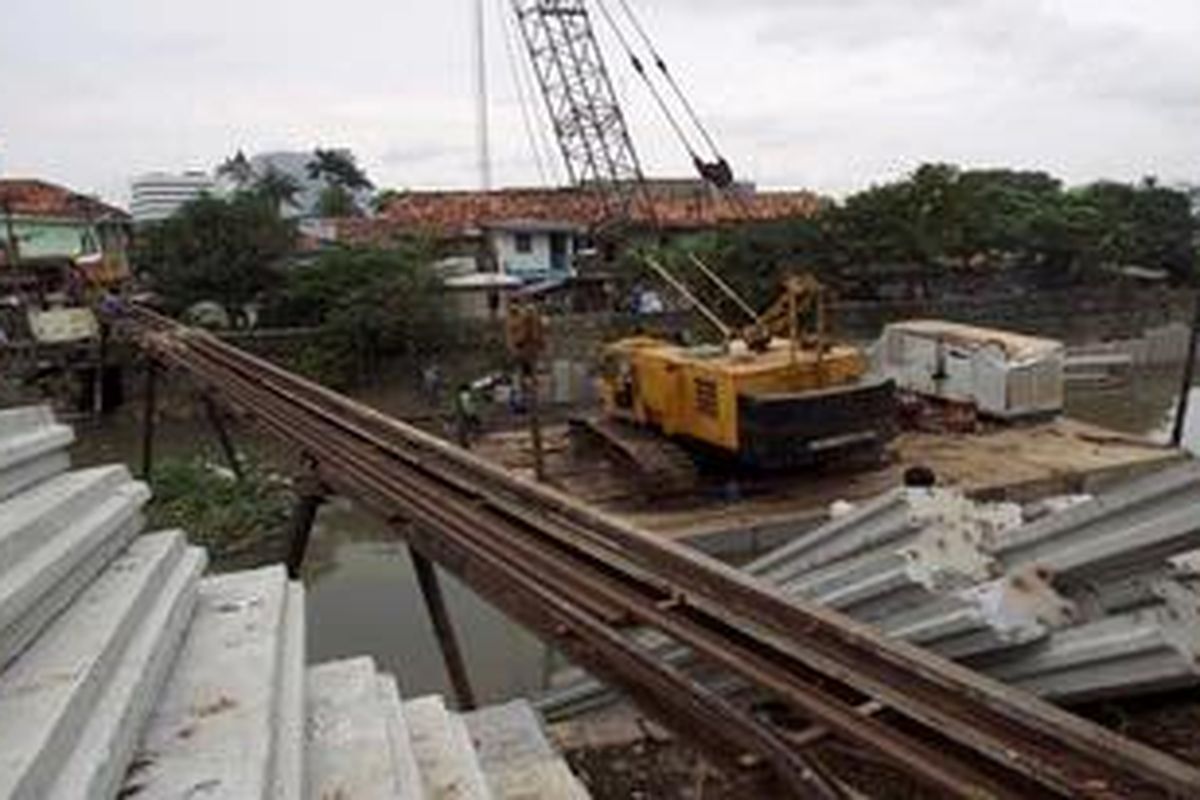 Alat berat digunakan memasang turap untuk normalisasi bantaran Kali Ciliwung di Kelurahan Pegangsaan, Menteng, Jakarta Pusat, Rabu (30/1/2013). Normalisasi Kali Ciliwung sepanjang 20 kilometer terus dilakukan untuk mengurangi banjir yang kerap melanda di sekitar alur sungai yang dilaluinya. Proyek normalisasi Ciliwung ini dianggarkan sebesar Rp 1,2  triliun.
