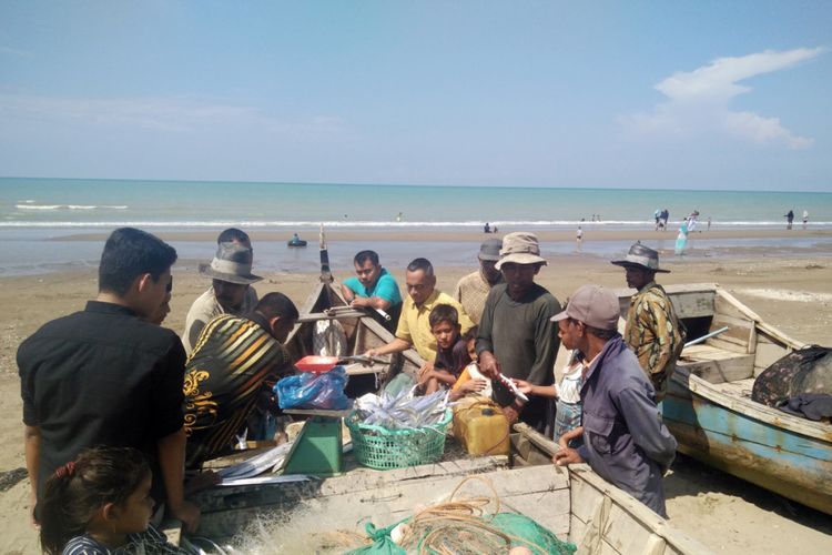 Wisatawan memilih ikan untuk dibeli dari nelayan di Pantai Bantayan, Desa Ulee Rubek, Kecamatan Seunuddon, Kabupaten Aceh Utara, Aceh, Minggu (3/2/2019).