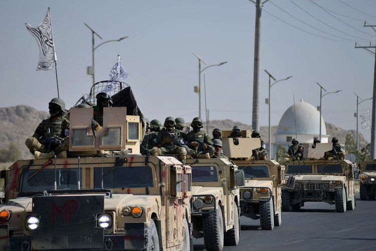 Pasukan Taliban dari korps Al-Badr duduk di atas kendaraan lapis baja selama parade di Kandahar, Afghanistan, pada 8 November 2021.