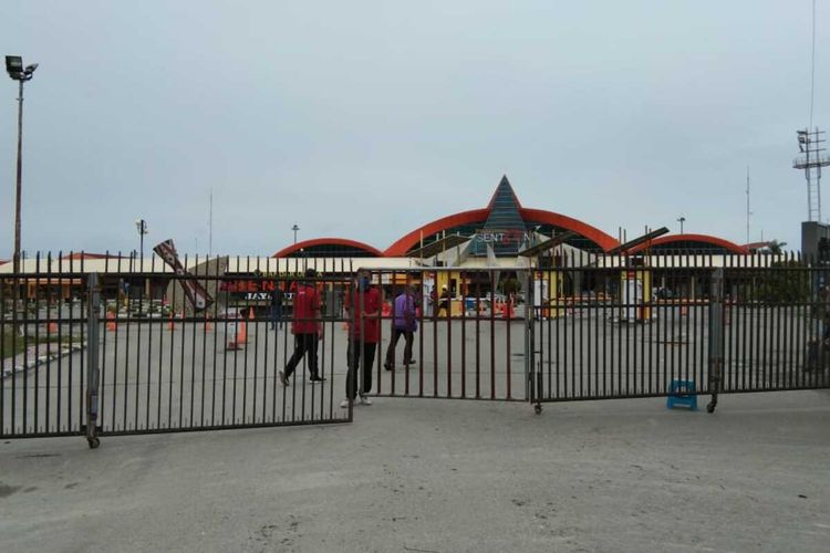 Petugas Bandara Sentani, Kabupaten Jayapura, menutup pagar sebagai tanda bahwa aktifitas di lokasi tersebut dihentikan untuk mencegah penyebaran virus corona, Papua, Kamis (26/3/2020)