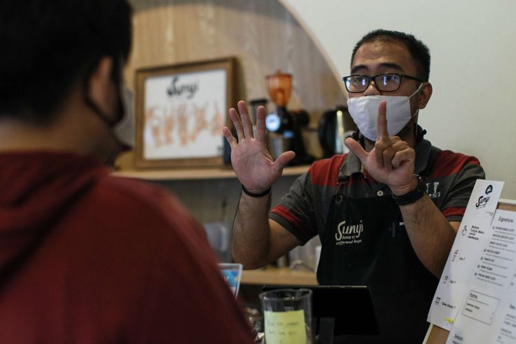 Paul, barista Kafe Sunyi House of Coffee and Hope, Jakarta melayani pelanggan yang datang, Rabu (10/2/2021). Semua pekerja yang ada di Kafe Sunyi ini adalah orang  orang penyandang disabilitas.