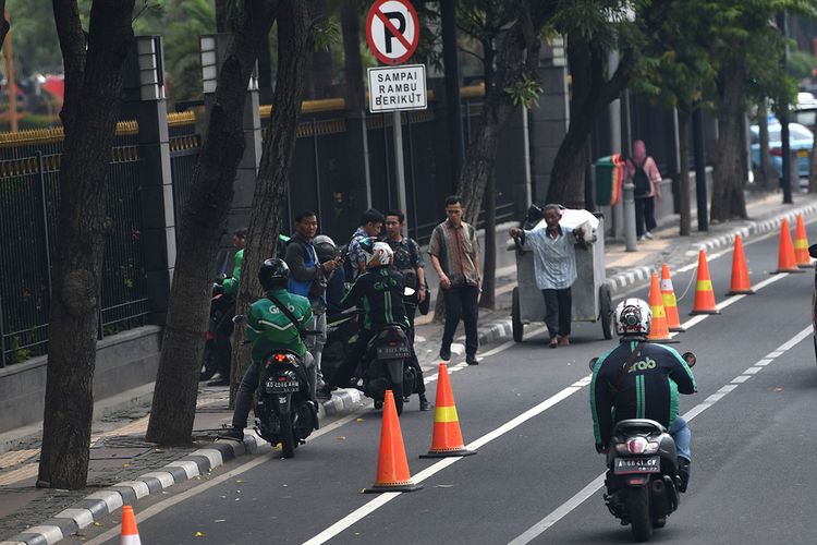 Sejumlah pengendara sepeda motor melanggar jalur sepeda di Jalan MH Thamrin, Jakarta, Jumat (22/11/2019). Polda Metro Jaya bekerja sama dengan Dishub DKI Jakarta mulai menerapkan aturan jalur sepeda dengan memberikan sanksi denda tilang maksimum Rp500 ribu hingga penderekan kendaraan bagi pengendara kendaraan bermotor yang melanggar jalur sepeda.