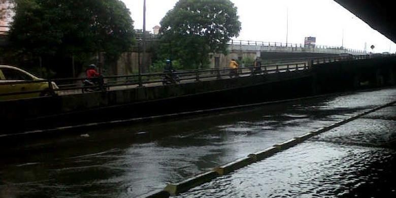 Pengendara sepeda motor memasuki pintu tol Sunter untuk menghindari banjir di ruas Jalan Yos Sudarso, Rabu (5/2/2014).