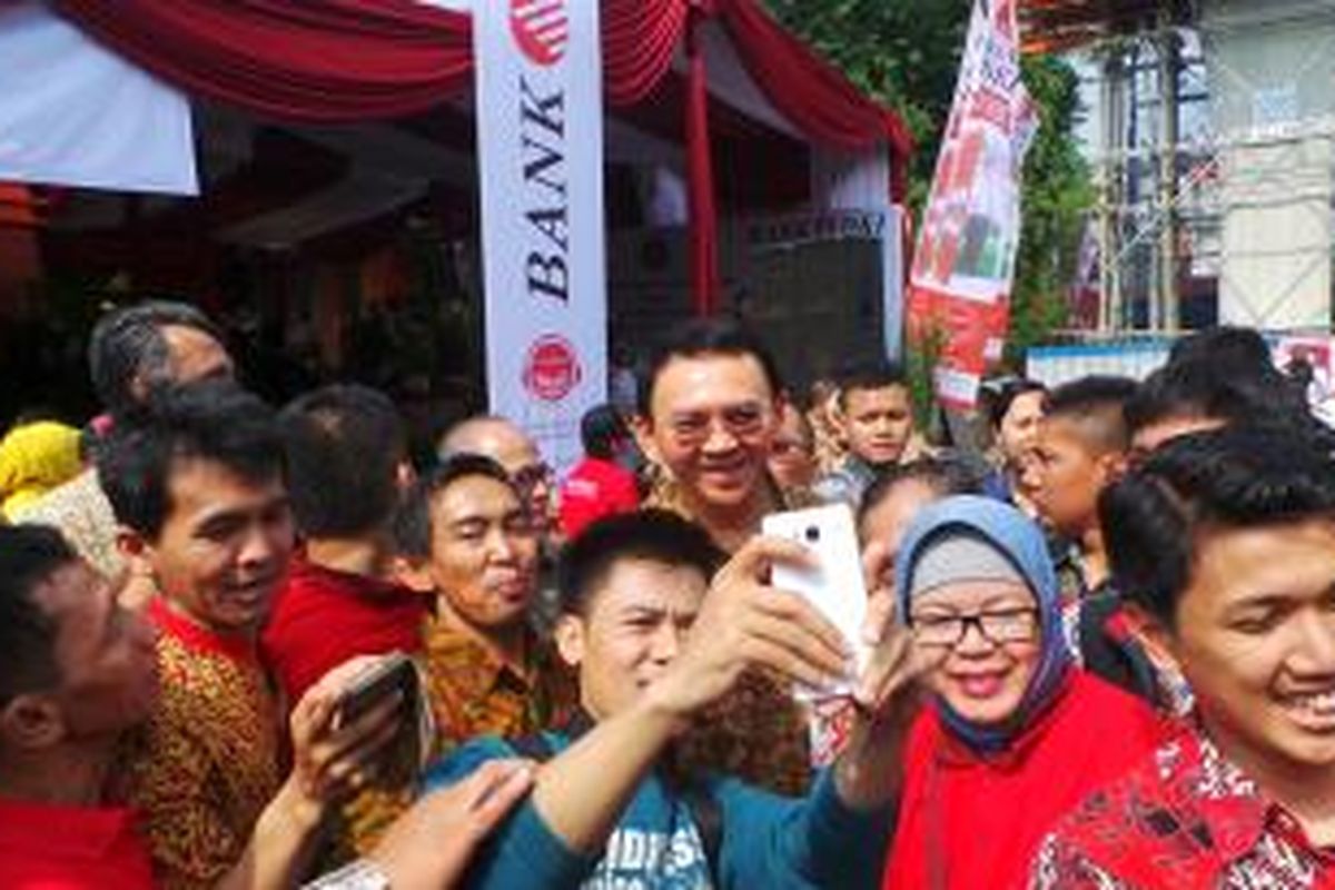 gubernur DKI Jakarta Basuki Tjahaja Purnama selfie dengan pedagang Pasar Taman Puring, Jumat (30/10/2015). 