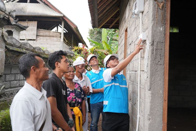 Senyum bahagia terpancar dari I Nyoman Nuki (tengah) dan Made Rasmi (kedua dari kanan), pasangan suami istri penerima manfaat bantuan penyambungan listrik gratis PLN. Penyerahan simbolis dilakukan oleh GM PLN UID Bali Eric Rossi Priyo Nugroho (kedua kiri) dan Wakil Walikota Denpasar, I Kadek Agus Arya Wibawa (kiri) di Denpasar, Senin (21/10/2025).