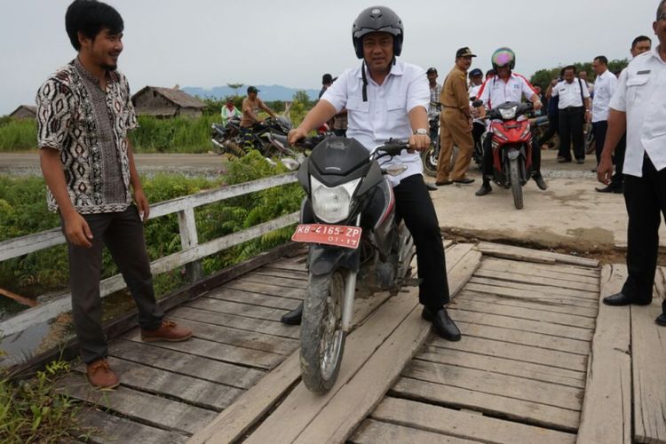 Wali Kota Semarang Hendrar Prihadi mengendarai motor untuk bertemu para transmigran di Kalimantan Barat, Rabu (27/9/2017). Perjalanan menggunakan motor sejauh puluhan kilometer itu karena medan yang dilalui sulit dan tidak bisa diakses dengan mobil. 