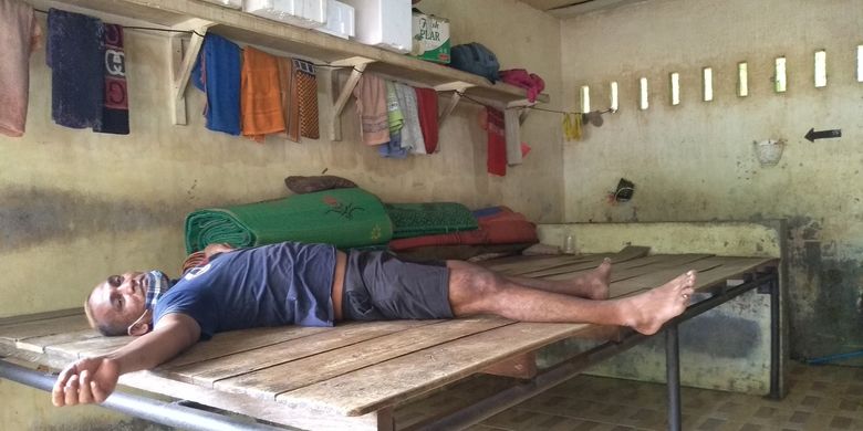 JS Sitepu (38) sedang tiduran di papan kayu di dalam kerangkeng yang ada di belakang rumah Bupati nonaktif Langkat, Terbit Rencana Perangin-angin pada Rabu (26/1/2022). Dia pernah di situ selama 1 tahun lebih pada 2019 karena narkoba dan kini sudah tak mau menyentuh narkoba lagi.