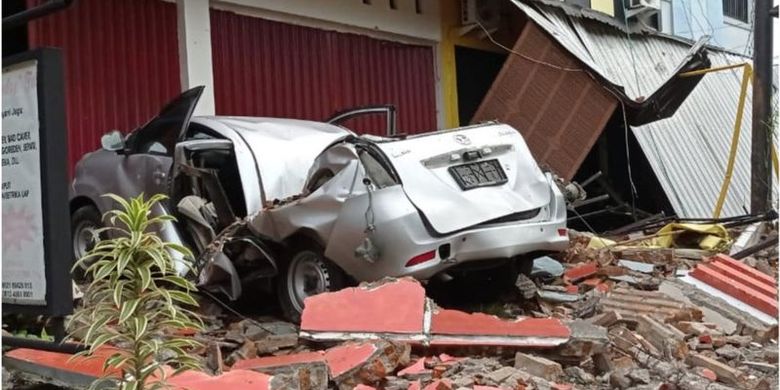 Sebuah mobil dan bangunan rusak akibat gempa bumi, di Mamuju, Sulawesi Barat, Jumat (15/1/2021).