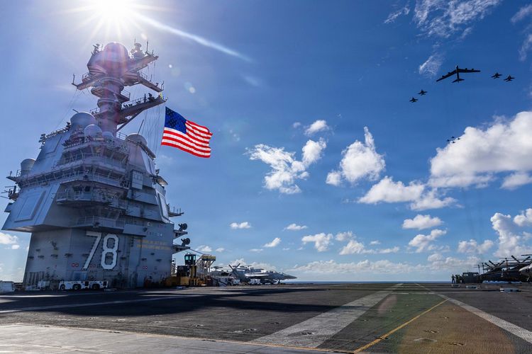 Kapal induk Amerika Serikat USS Gerald R Ford saat dipotret di laut bersama jet tempur F/A-18E/F Super Hornets dan B-52 Stratofortress di lokasi yang tak disebutkan di laut, 13 November 2025.