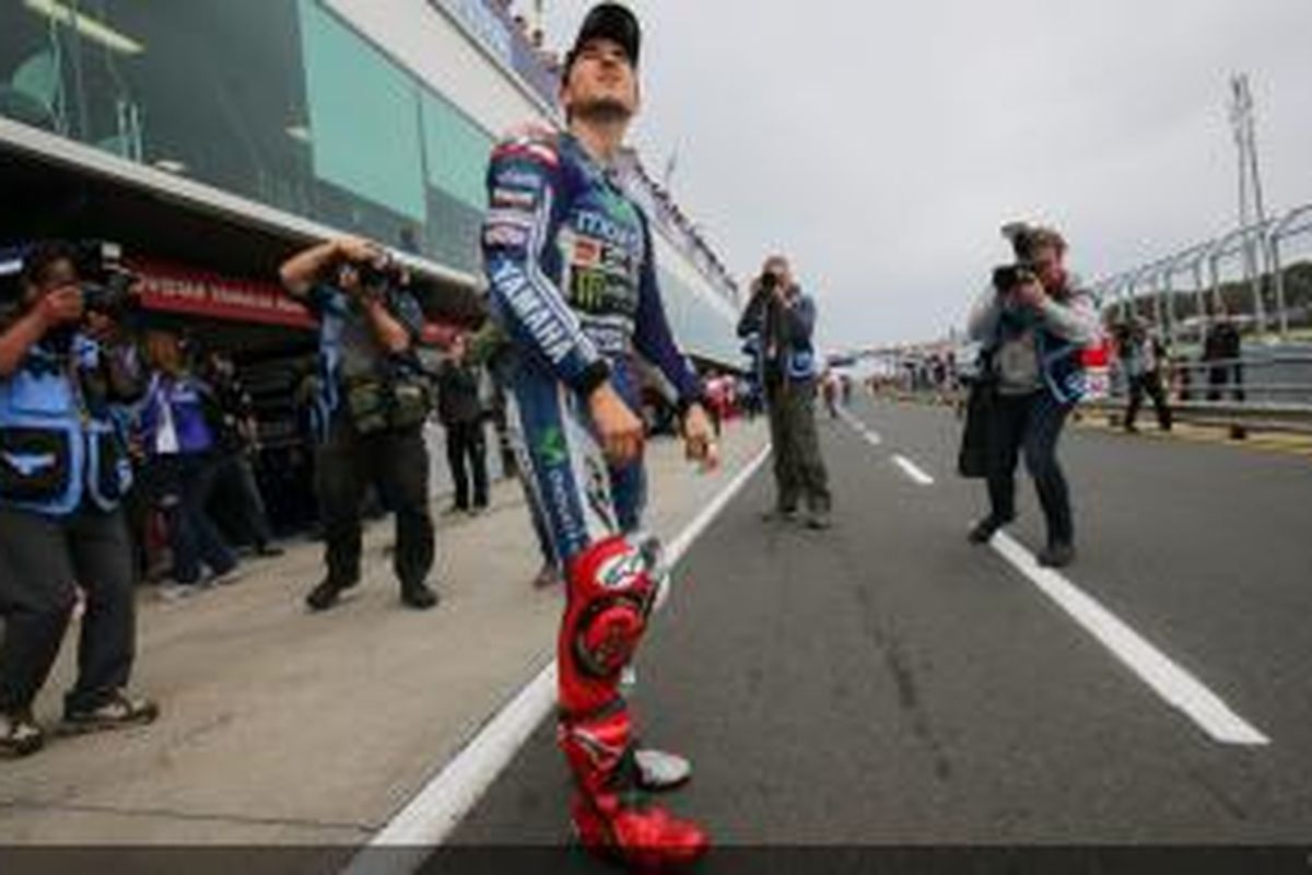 Pebalap Movistar Yamaha asal Spanyol, Jorge Lorenzo, menengadah ke langit untuk memeriksa kondisi cuaca, jelang sesi kualifikasi GP Australia di Sirkuit Phillip Island, Sabtu (18/10/2014).