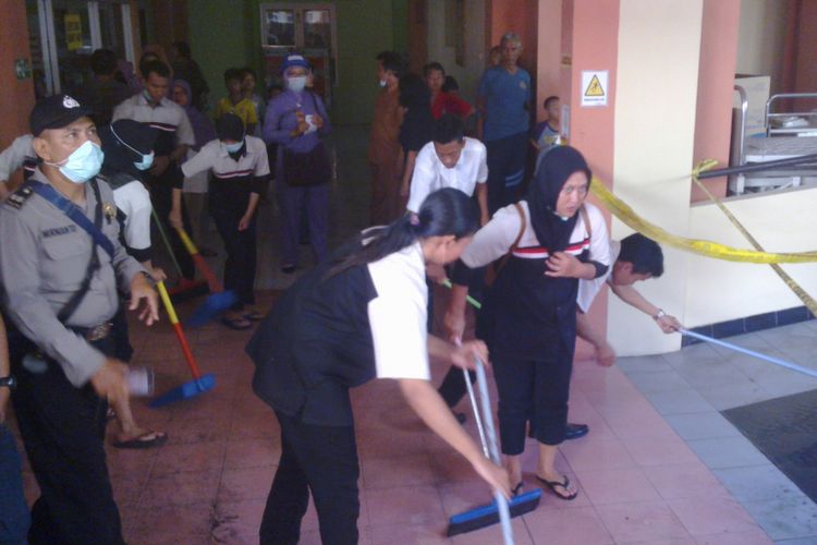 Petugas membersihkan lantai usai kebakaran di RS.Bhayangkara Kota Kediri, Jawa Timur, Senin (1/5/2017).