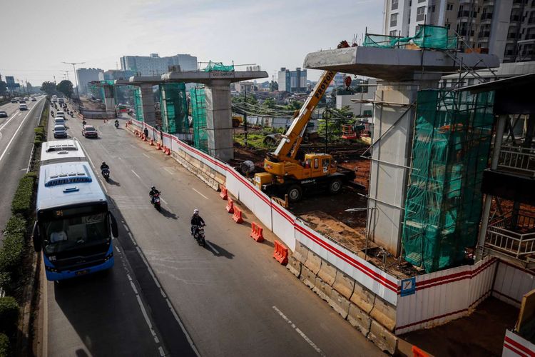 Pengendara melintas di samping lokasi pembangunan Light Rail Transit (LRT) Cawang-Pancoran di Jakarta, Sabtu (24/2/2018). Progres proyek pembangunan kereta api ringan atau Light Rail Transit (LRT) tahap I yang meliputi relasi Cibubur-Cawang, Bekasi Timur-Cawang dan Cawang-Dukuh Atas secara keseluruhan mencapai 20 persen dan ditargetkan selesai pada 2019.