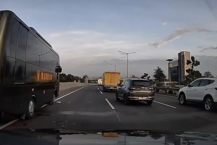 Bus Mabes AD yang berada tengah berhenti di sisi kiri Tol JORR.