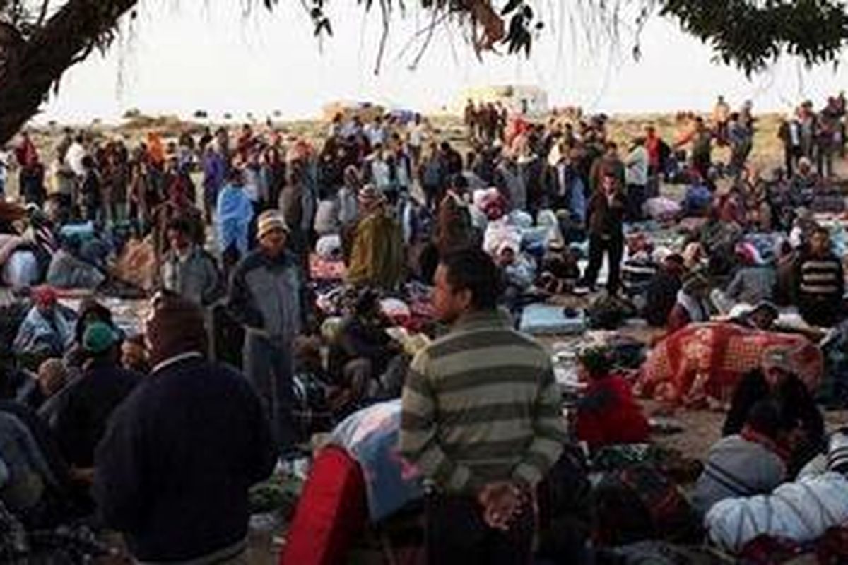 Men who recently crossed into Tunisia from Libya rest in a United Nations displacement camp on March 6, 2011 in Ras Jdir, Tunisia. As fighting continues in and around the Libyan capital of Tripoli, tens of thousands of guest workers from Egypt, Tunisia, Bangladesh and other countries are fleeing to the border of Tunisia to escape the violence. The situation has turned into a humanitarian emergency as fledgling Tunisia is overwhelmed with the workers. Libyan leader Muammar Gaddafi has vowed to fight to the end.